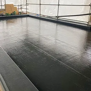 a black floor in a room with a white wall