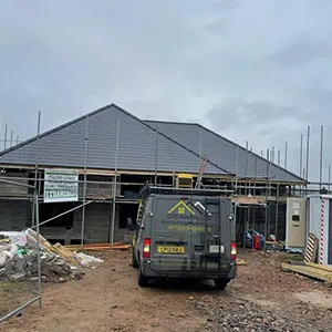 a van parked in front of a building under construction