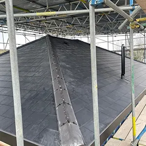 a large metal structure with a black tarp on top of it