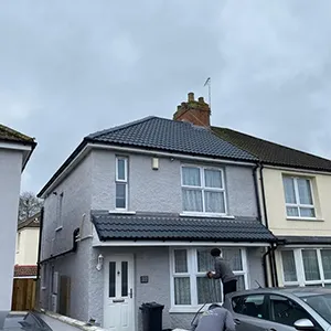 a couple of cars parked in front of a house