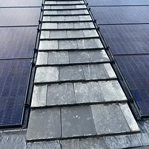 a row of solar panels on the roof of a building