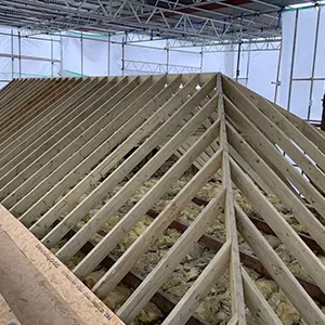 a large wooden structure in a building under construction